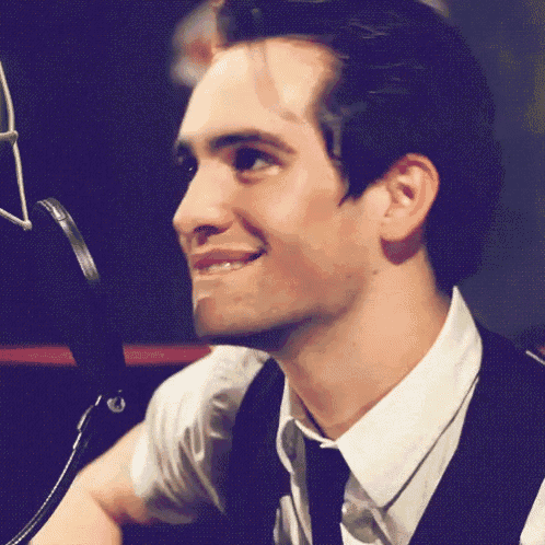 a close up of a man 's face with a microphone in the background