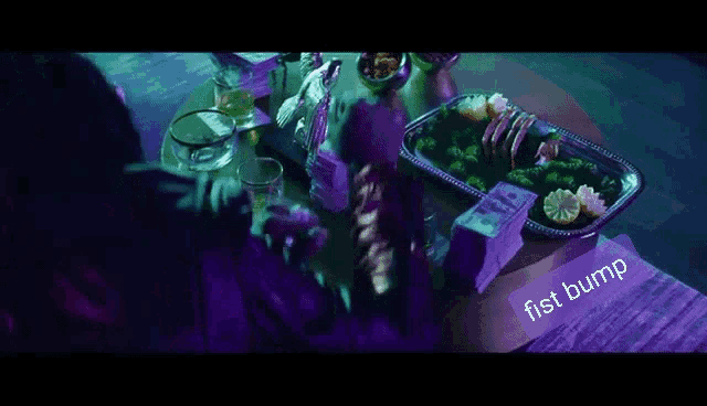 a person sitting at a table with a tray of food and the word fist bump on the bottom