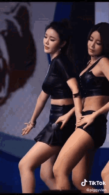 two women are dancing on a stage with a tiktok watermark