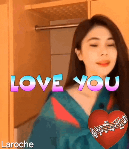 a woman is standing in front of a sign that says i love you