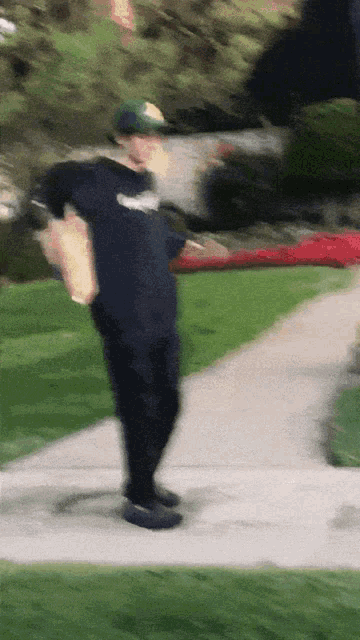 a blurry picture of a man walking down a sidewalk