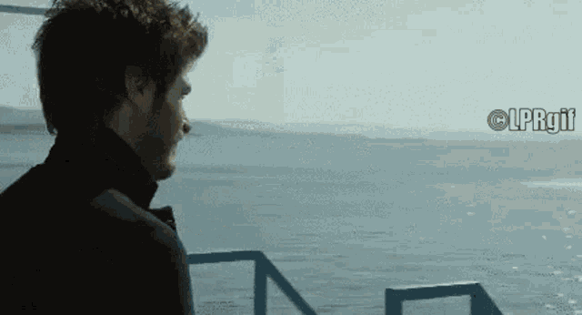 a man looking out over a body of water with the words lprgif written below him