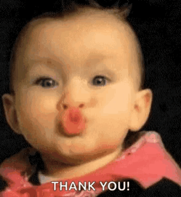 a baby is blowing a kiss and saying `` thank you ! ''