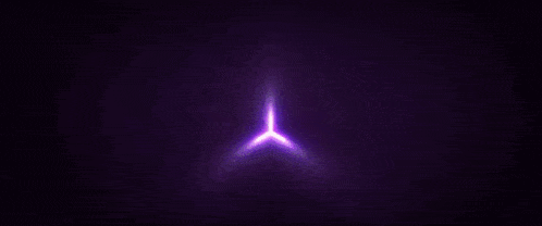 a purple cube with lines coming out of it is floating in the air .
