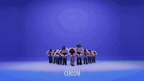 a group of women are dancing in front of a blue background with the word choom written on it