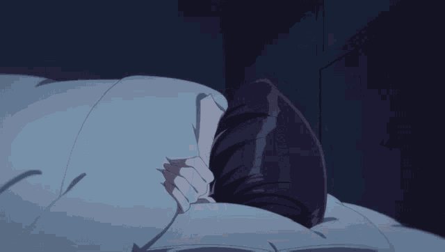 a girl with purple hair is sleeping in a bed with a blue comforter