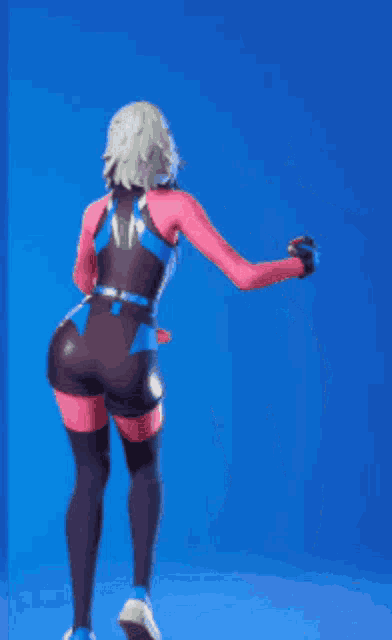 a woman in a pink and blue outfit is standing with her arms outstretched in front of a blue background .