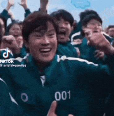 a group of people are playing a game called squid game and one of them is wearing a number 001 jacket .