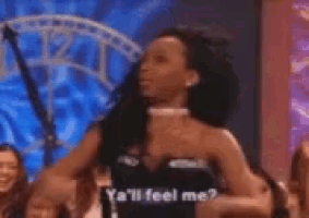 a woman is standing in front of a crowd and says ya 'll feel me