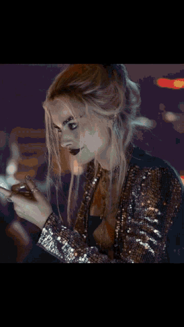 harley quinn is smiling while holding a glass of beer
