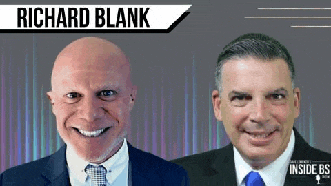 two men in suits and ties are smiling and looking at the camera .