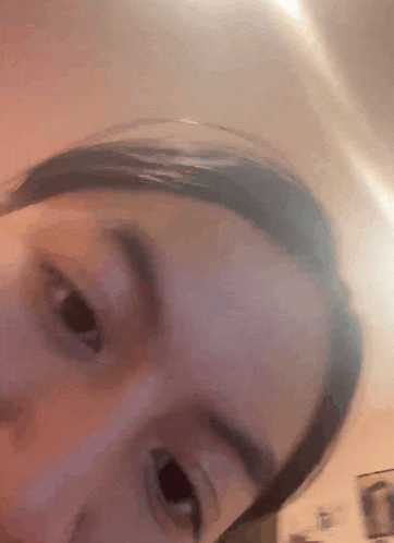 a close up of a person 's face with a blurry background .