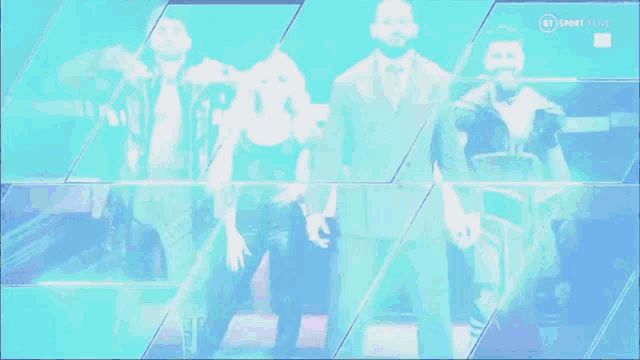 a group of wrestlers are standing in front of a blue background that says bt sport live .