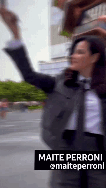 a blurred image of a woman with the name maite perroni on the bottom