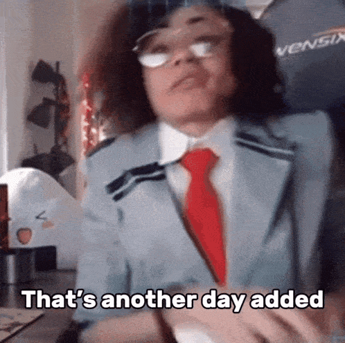 a man in a suit and tie is sitting at a desk and says `` that 's another day added '' .