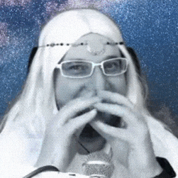 a man wearing glasses and a white wig is covering his mouth