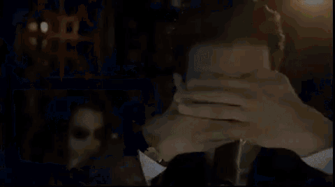 a man covering his face with his hands while a woman looks on