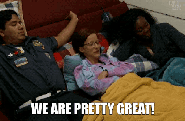 a man and two women are laying on a couch with the words we are pretty great