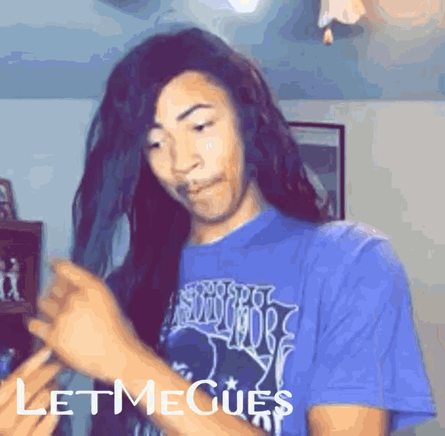 a man with long hair is wearing a purple shirt that says let me goes