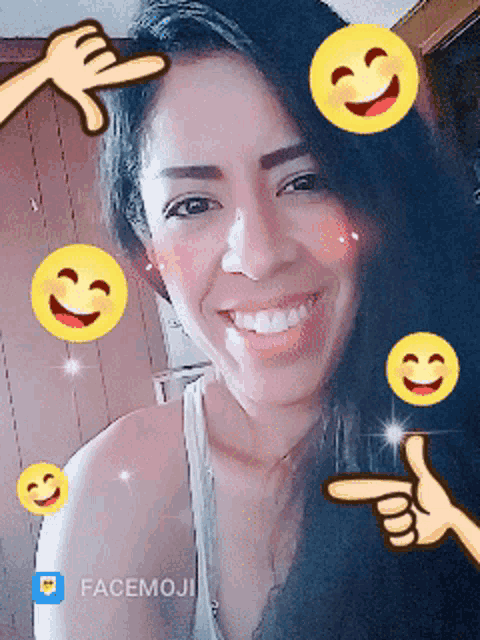 a woman is surrounded by smiley faces and pointing with facemoji in the corner