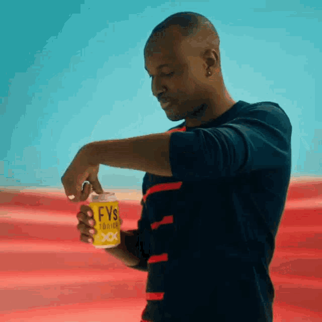 a man holding a can of fys cooler