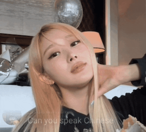 a woman with blonde hair has the words can you speak chinese written below her