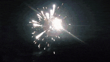 a fireworks display in the night sky with a few sparks