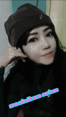 a woman wearing a beanie and a black turtleneck with the words waalaikum salam on the bottom
