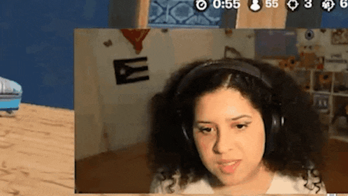 a woman wearing headphones is looking at a screen with the number 55 at the top