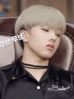 a young man with blonde hair is wearing a black shirt that says bakery