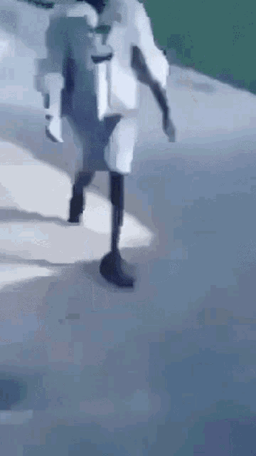 a man with a prosthetic leg is walking down a street .