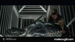 a man is standing next to a large dinosaur with the website make a gif.com below him