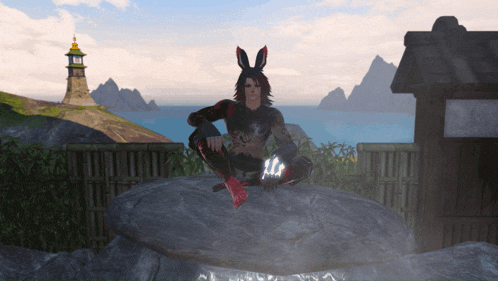 a man with bunny ears sits on a rock in front of a lighthouse