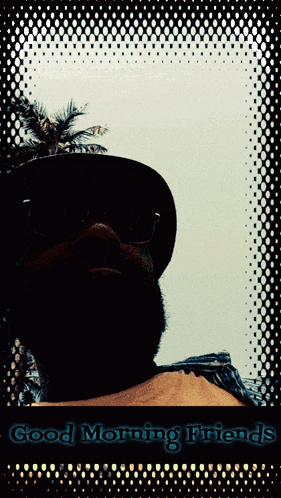 a man wearing glasses and a hat with the words " good morning friends " on the bottom