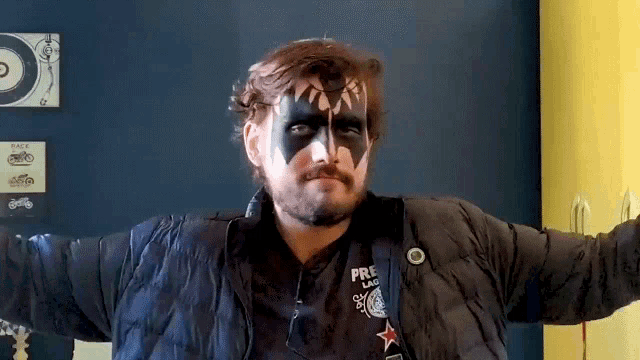 a man with face paint and a jacket that says pre lad