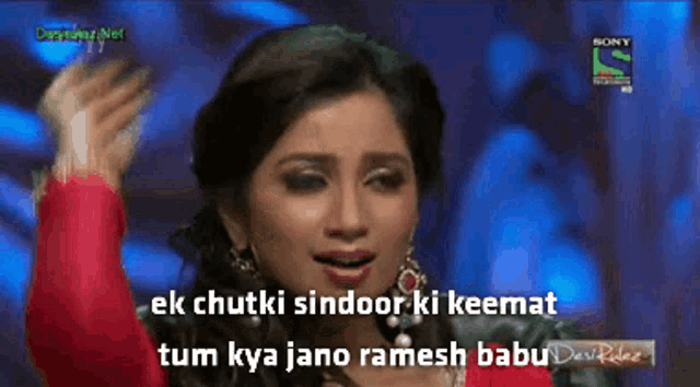 a woman singing in front of a sign that says sony television