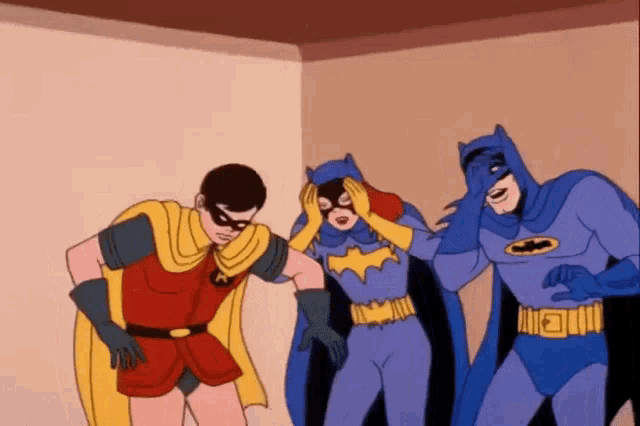 robin and batman are standing next to each other in a room .
