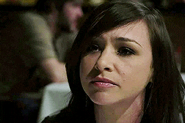 a close up of a woman 's face with a serious look on her face .