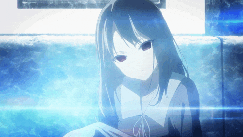 a girl with long black hair is sitting in a dark room
