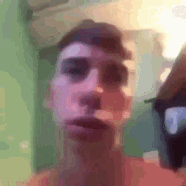 a blurry picture of a person 's face with a green background