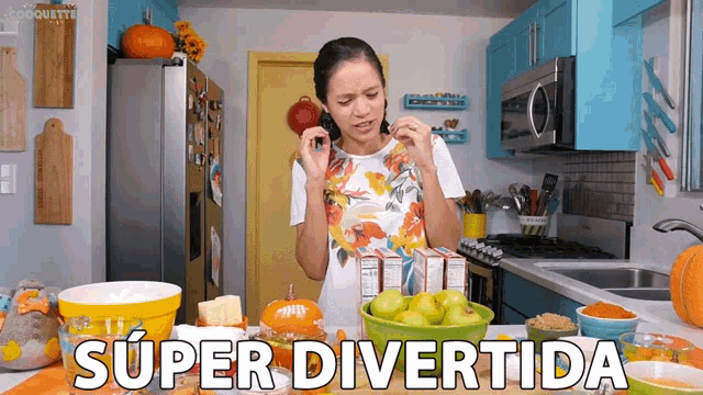 a woman in a kitchen with the words super divertida written on the counter