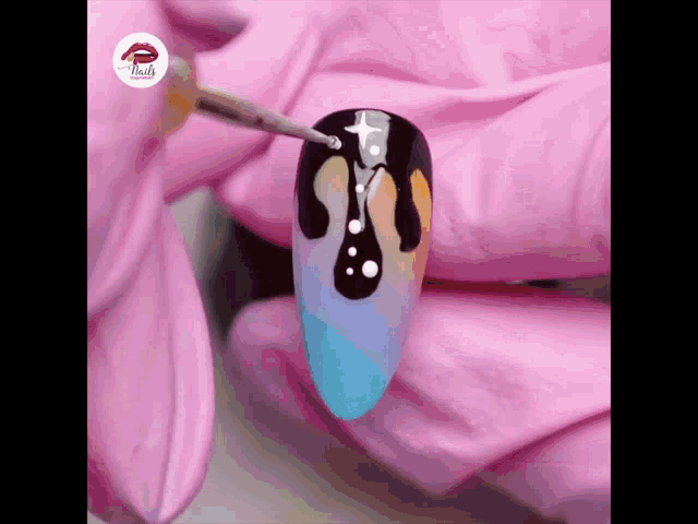 a close up of a nail being painted with a pink glove that says nails on it