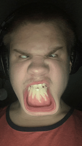 a man wearing headphones is making a funny face with his mouth open