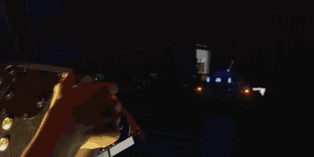 two go karts are racing on a race track at night