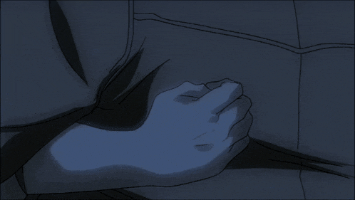 a person 's hand is on another person 's chest in a dark room