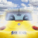 a yellow car is driving down a road with clouds in the background .