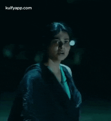 a close up of a woman 's face in the dark .