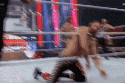 a man is laying on the ground in a wrestling ring