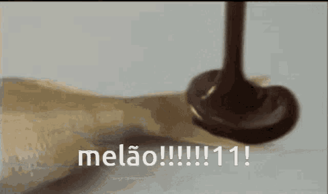 a spoon of chocolate is being poured on a piece of paper .