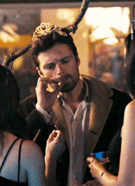 a man wearing a crown is smoking a cigar